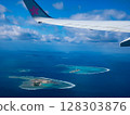 Spectacular view of the blue ocean and islands from the airplane window: Beautiful natural scenery from the sky 128303876