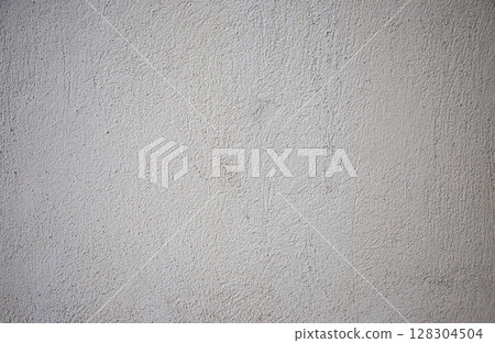 Textured gray wall surface displaying subtle variations in shade and depth, enhancing the minimalistic aesthetic of indoor spaces and contemporary designs 128304504