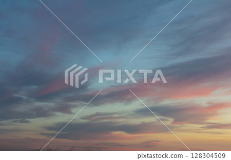 Colorful twilight sky filled with clouds at sunset above a serene landscape capturing a moment of tranquility and beauty Colorful twilight sky filled with clouds at sunset above a serene landscape capturing a moment of tranquility and beauty 128304509