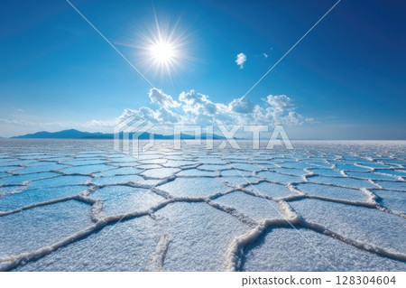 white hexagonal salt lake floor with a blue sky and sun 128304604