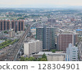 A view of Fukushima cityscape, with a train line and skyscrapers 128304901