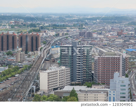 A view of Fukushima cityscape, with a train line and skyscrapers A view of Fukushima cityscape, with a train line and skyscrapers 128304901