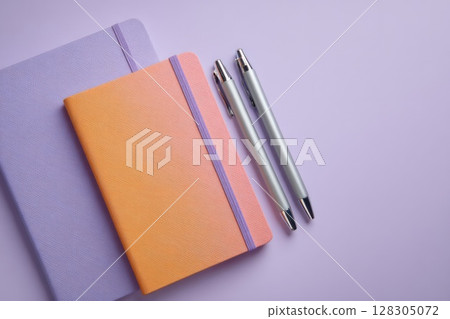 notebook with two silver pens 128305072