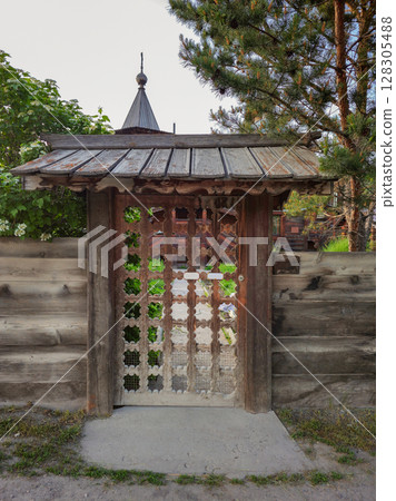 old carved wooden gate in old wooden church 128305488