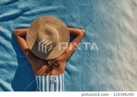 top view of a woman sunbathing on the beach 128306200