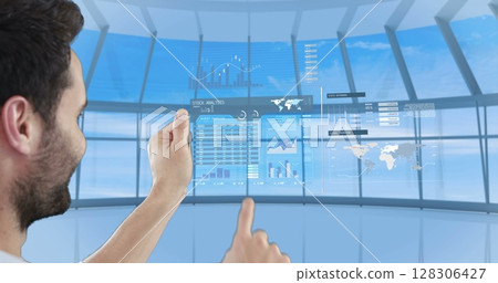 Using futuristic digital tablet, man interacting with holographic interface 128306427