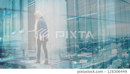Image of asian woman in hijab walking in city over cityscape Image of asian woman in hijab walking in city over cityscape 128306449