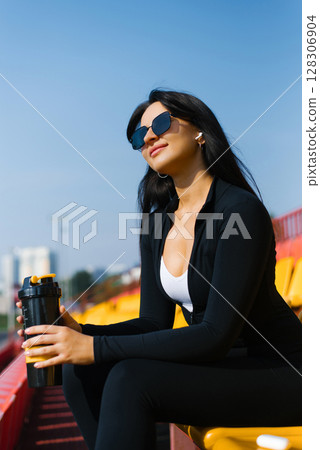 Athletic Woman Relaxing With Sports Shaker Athletic Woman Relaxing With Sports Shaker 128306904