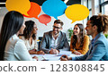 A diverse group of smiling business professionals sit around a table with colorful speech bubbles floating above, representing active communication and collaboration. - Generic AI Image 128308845