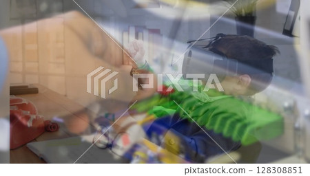 Using VR headset, child experiencing virtual reality over office desk with documents 128308851