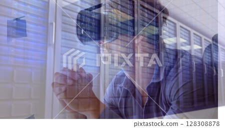 Digital composite of businessman using VR while sitting and looking thoughtful in Server Room agains Digital composite of businessman using VR while sitting and looking thoughtful in Server Room agains 128308878
