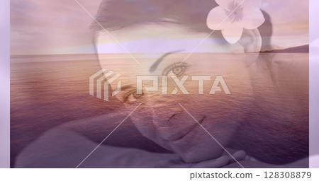 Portrait of a relaxed smiling women with flower in her hair and sea landscape for valentine day 4k 128308879