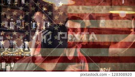 Digital composite of men at sportsbar celebrating against american flag background Digital composite of men at sportsbar celebrating against american flag background 128308920