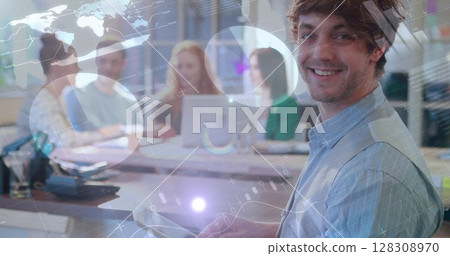 Image of graphs, data and digital interface over smiling man using tablet computer in casual office Image of graphs, data and digital interface over smiling man using tablet computer in casual office 128308970