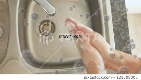 Washing hands with soap at kitchen sink, promoting stay at home safety 128309003