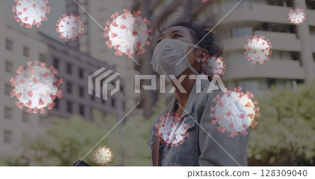 Woman wearing mask outdoors surrounded by digital virus graphics, looking upwards 128309040