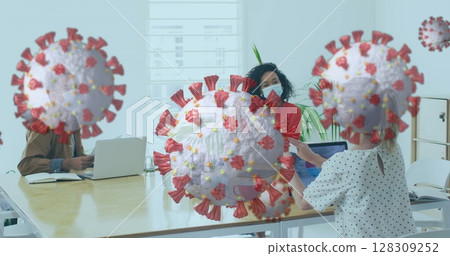 Image of floating covid-19 cells with colleagues in office wearing face masks 128309252