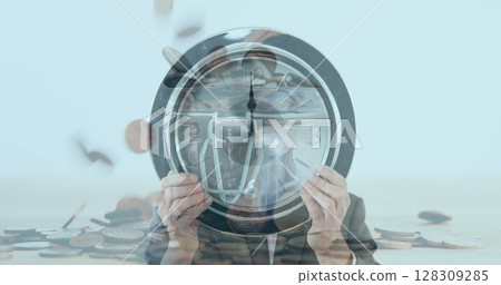 Businessman holding clock against his face against coins falling in background 128309285