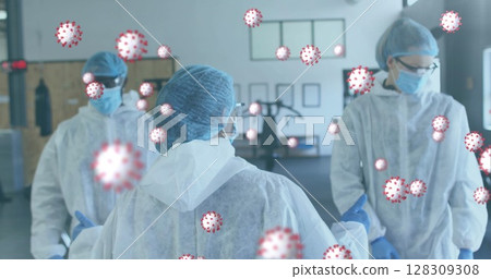 Covid-19 cells floating against team of health workers discussing together at gym 128309308