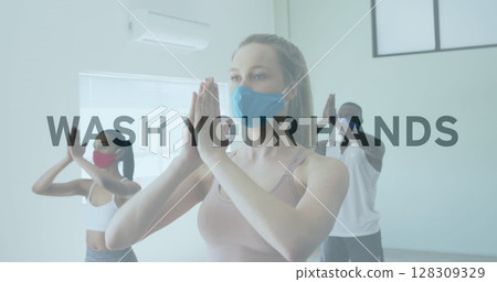 Image of words flashing over diverse group wearing face masks practising yoga Image of words flashing over diverse group wearing face masks practising yoga 128309329