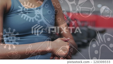 Image of covid-19 icons floating over caucasian woman wiping hands working out Image of covid-19 icons floating over caucasian woman wiping hands working out 128309333