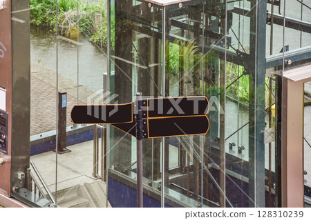 an elevator in the middle of a building with glass doors and railings on either side, there is a view from above an elevator in the middle of a building with glass doors and railings on either side, there is a view from above 128310239