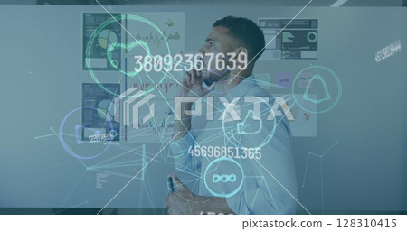 Image of interface with connected media icons with man talking on phone in office Image of interface with connected media icons with man talking on phone in office 128310415