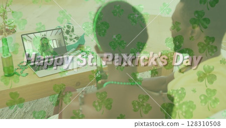 Happy st patricks day text and clover leaves against couple having image call on laptop at home Happy st patricks day text and clover leaves against couple having image call on laptop at home 128310508