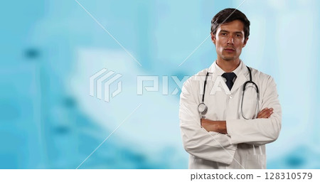 Portrait of caucasian male doctor with arms crossed against hospital in background 128310579