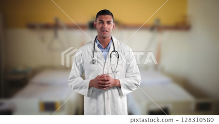 Image of portrait of male doctor with stethoscope talking over out of focus hospital 128310580