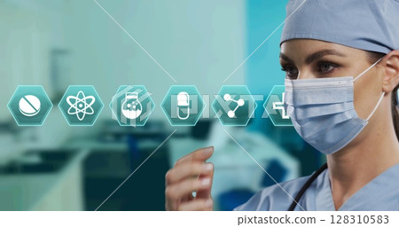 Image of hexagon medical icons over female doctor wearing face mask Image of hexagon medical icons over female doctor wearing face mask 128310583