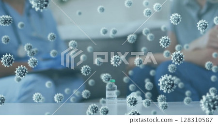 Multiple covid-19 cells floating against covid-19 vaccine bottle on the table at home Multiple covid-19 cells floating against covid-19 vaccine bottle on the table at home 128310587