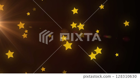 Image of multiple yellow stars falling on brown background with glowing light Image of multiple yellow stars falling on brown background with glowing light 128310630