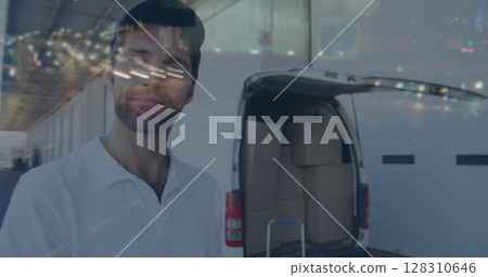 Image of road traffic over happy delivery man next to van in shipping centre 128310646