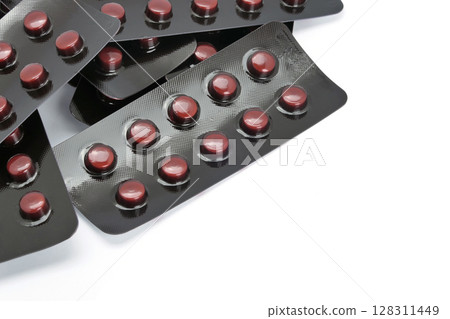 Tablets in foil blister packs on white background 128311449