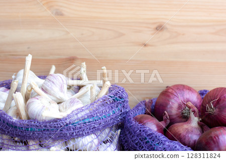 Garlic and red onion in nylon nets bags, harvest 128311824