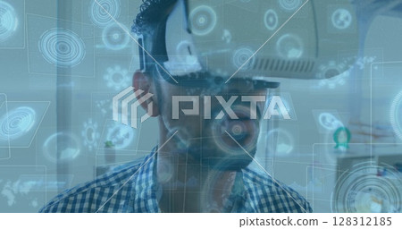 Image of scopes scanning on screens over man wearing vr headset 128312185