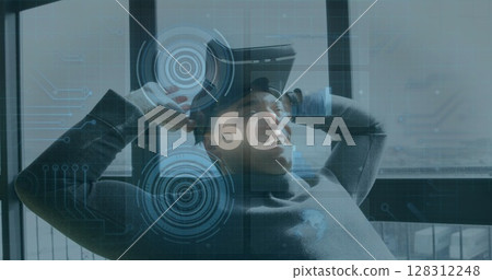 Image of 6g text, scopes scanning and data processing over smiling man wearing vr headset 128312248