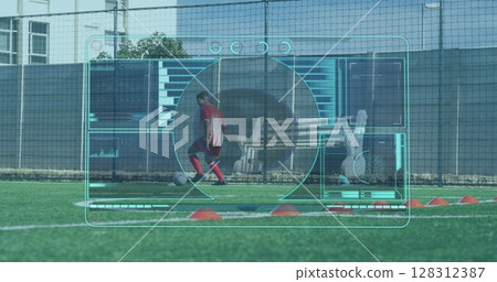 Image of scope scanning over male football player playing with football on pitch 128312387