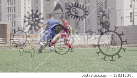Image of covid 19 icons over two teams of male football players during game on pitch 128312393