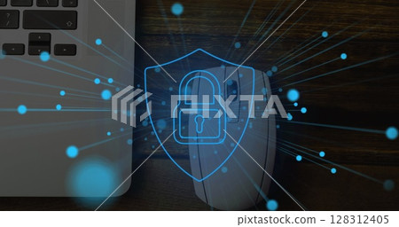 Image of online security padlock with blue spots over laptop and mouse in desk Image of online security padlock with blue spots over laptop and mouse in desk 128312405
