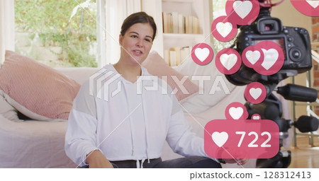 Image of love icons and numbers over female vlogger practicing yoga recording vlog at home Image of love icons and numbers over female vlogger practicing yoga recording vlog at home 128312413