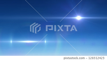 Image of glowing spot with lens flare on blue background Image of glowing spot with lens flare on blue background 128312423