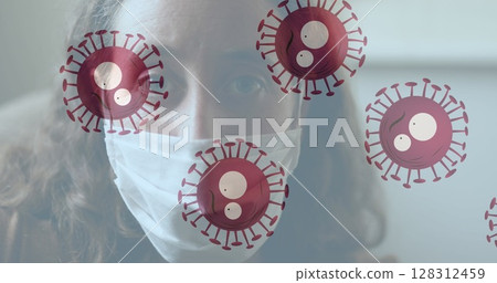 Multiple covid-19 cells moving against portrait of caucasian woman wearing face mask Multiple covid-19 cells moving against portrait of caucasian woman wearing face mask 128312459