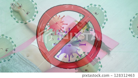 Stop sign over covid-19 cells moving against woman wearing face mask lying on yoga mat at the gym 128312463