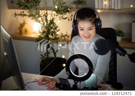 Podcast host preparing content in a cozy recording studio Podcast host preparing content in a cozy recording studio 128312471