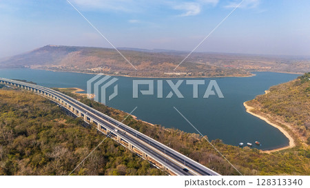 Drone shot aerial view landscape of the M6  motorway Expressway Nakhon Ratchasima Province - Bang Pa-in. Lam Ta Khong River and Mountain. Drone shot of scenic landscape rural place traffic. Nakhon 128313340