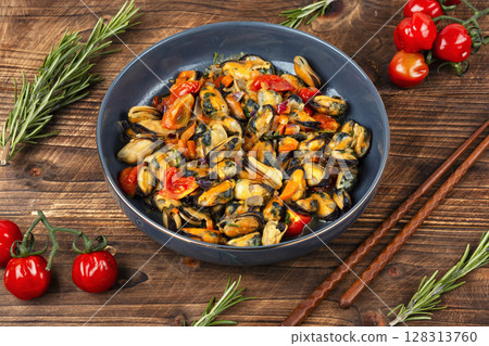 Plate of mussels on a table. Plate of mussels on a table. 128313760