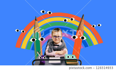 Confident schoolboy in collage sitting at desk with rainbow and giant cartoon pencils Confident schoolboy in collage sitting at desk with rainbow and giant cartoon pencils 128314933
