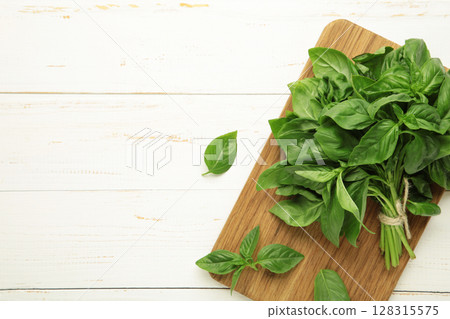 Fresh green basil leaves on white wooden background. Space for text 128315575